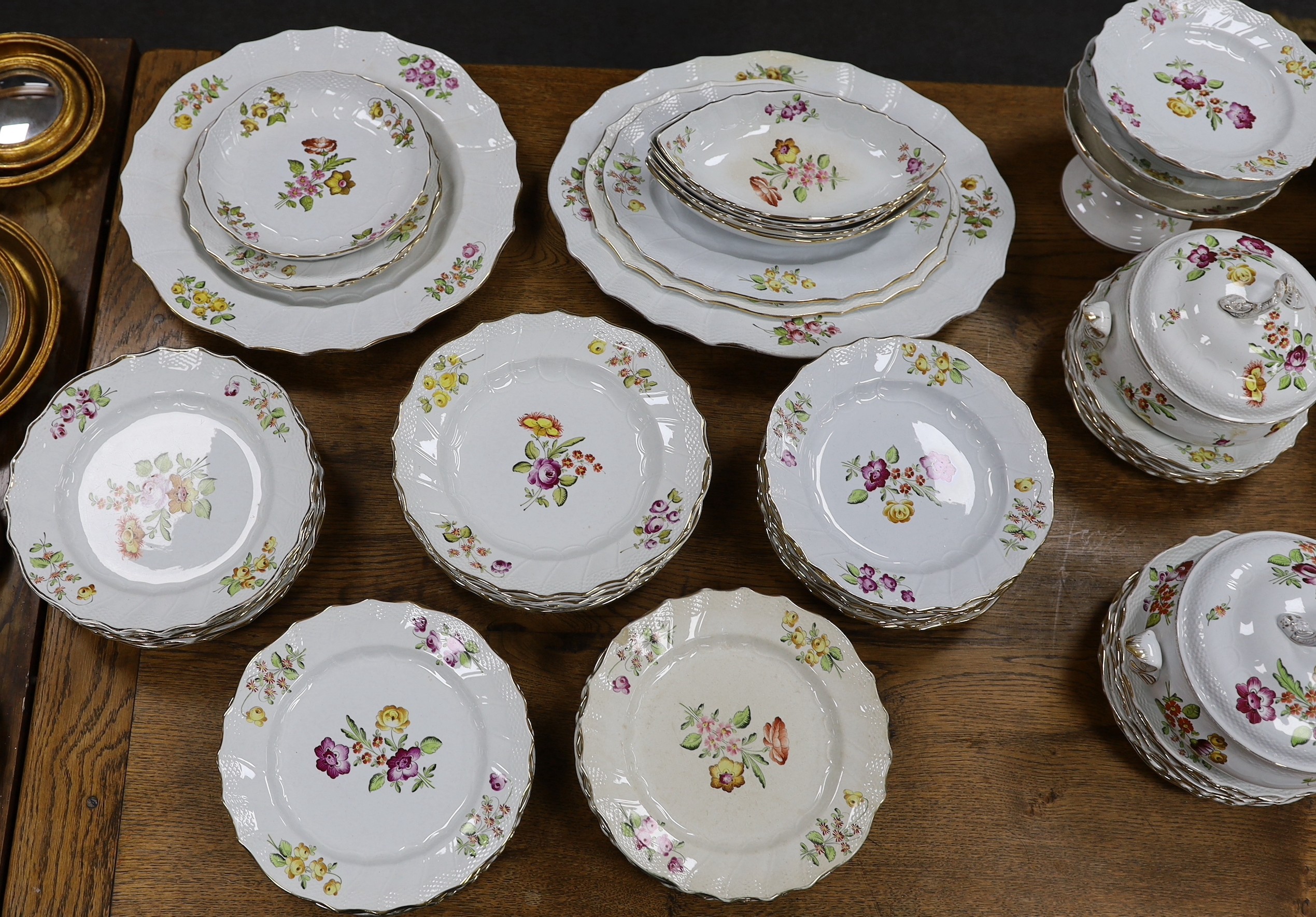 An extensive early 20th century Belgian floral painted earthenware dinner service